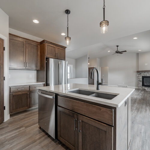 Image of the kitchen in a newly built home, highlighting its modern appliances, sleek design, and spacious layout.