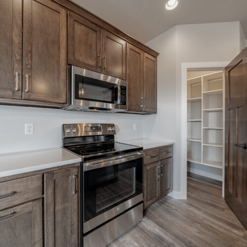 Image of the kitchen in a newly built home, highlighting its modern appliances, sleek design, and spacious layout.