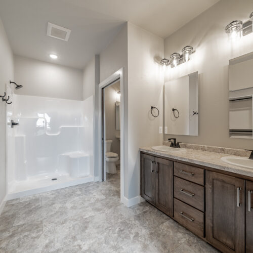 Image of a newly constructed home's master bathroom, featuring modern fixtures and a sleek design.