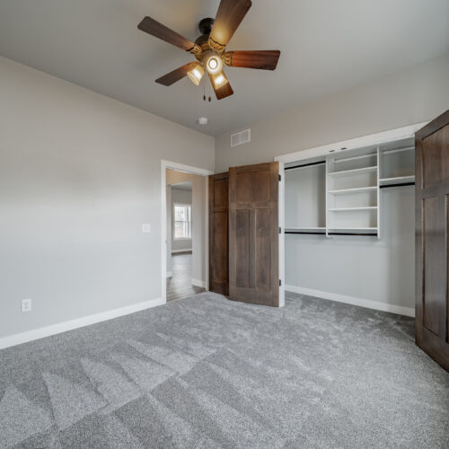Image of the master bedroom in a newly built home, showcasing its spacious layout, modern furnishings, and tasteful decor, creating a tranquil and inviting atmosphere.