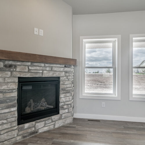 Image showing the fireplace of a newly constructed modern home. The photo highlights the contemporary design of the fireplace, its placement in the room, and the overall elegant and cozy ambiance it adds to the space