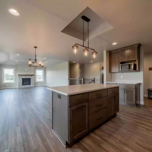 Wide-angle photo of the living room in the Milestone floor plan, showcasing its spacious and open-concept design. The image highlights the room's large area and the seamless flow into adjacent spaces, illustrating a contemporary and inviting living environment.