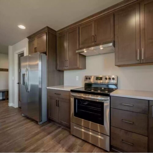 Close-up image of a kitchen, highlighting modern appliances including the refrigerator and stove. The photo showcases the sleek design and advanced features of these appliances, emphasizing their role in the kitchen's functionality and style.