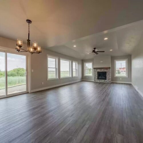 Wide view image of the living room in the Milestone floor plan highlights its spacious and open layout and inviting design, ideal for relaxation and social gatherings.