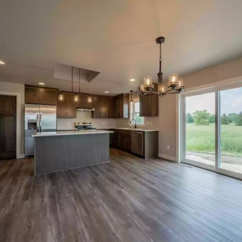 Wide view image of the kitchen in the Milestone floor plan, showcasing its expansive layout, modern appliances, and stylish design, reflecting a spacious and functional cooking and dining area.