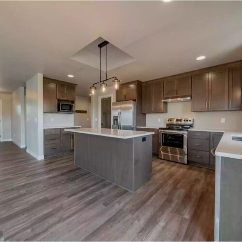 Image of the kitchen in the Milestone floor plan, highlighting the open concept design. The photo showcases a spacious layout, modern appliances, and seamless integration with surrounding living spaces.