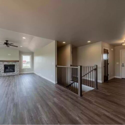 Image of the living room in the Milestone floor plan, featuring a spacious layout, contemporary furniture, and a welcoming ambiance.