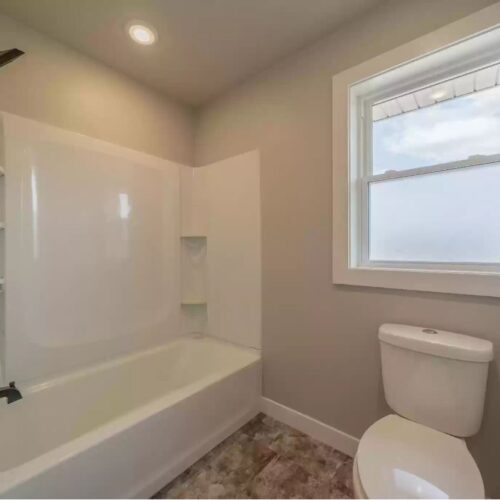 Image of a Milestone floor plan bathroom, highlighting the modern shower design.