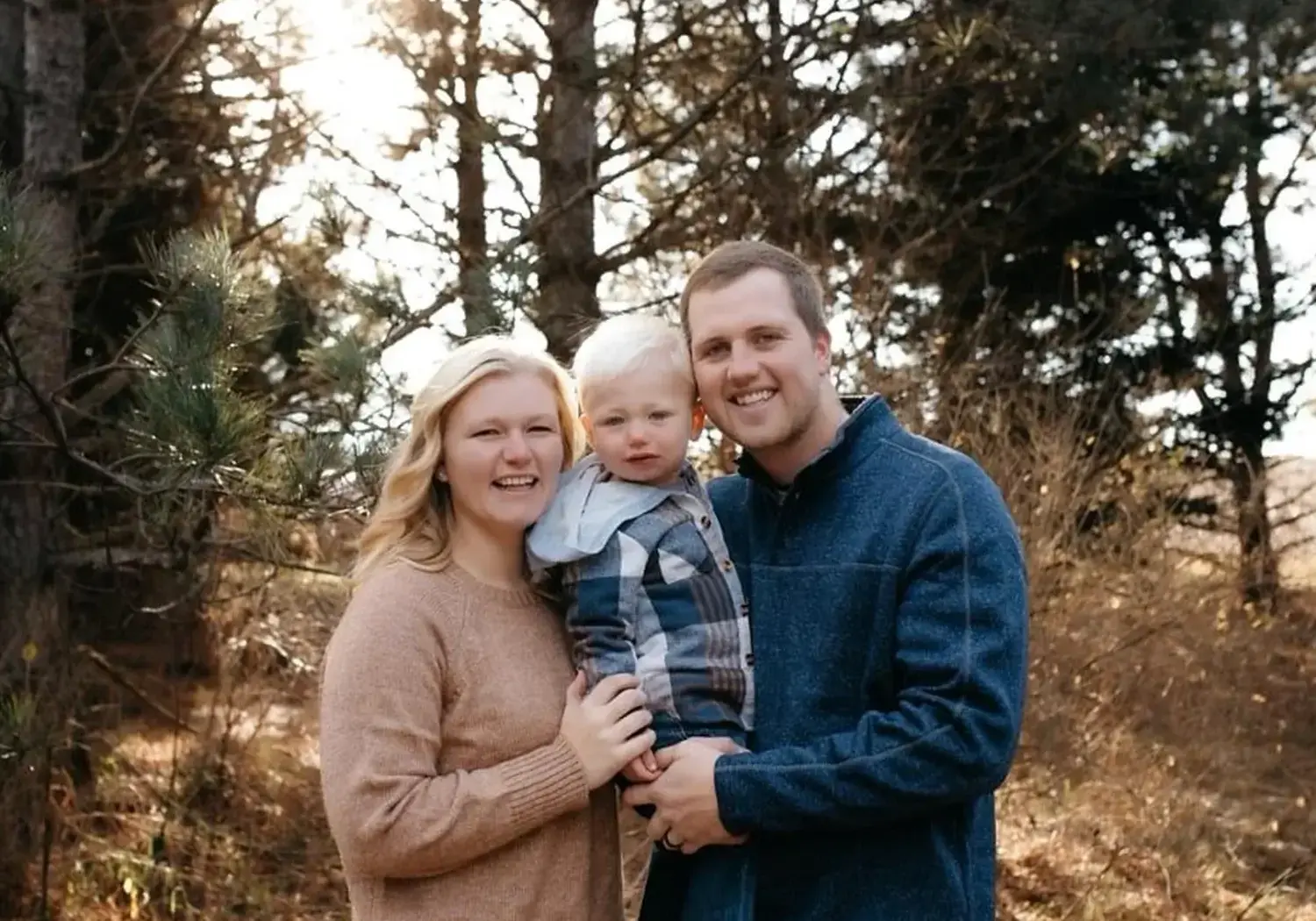 A photograph of Adam Bartz with his wife and son.